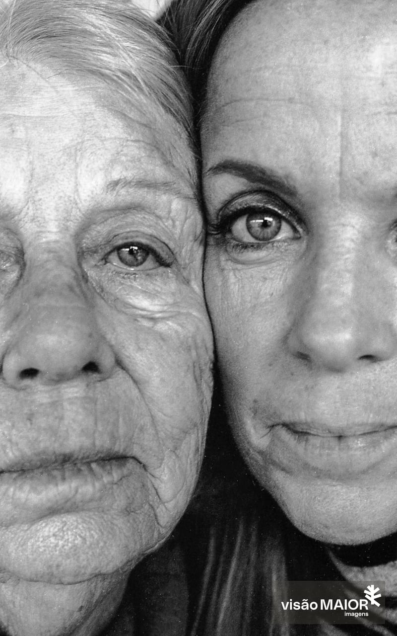 Duas mulheres de olhos claros com as caras coladas e parte dos rostos ocultos
